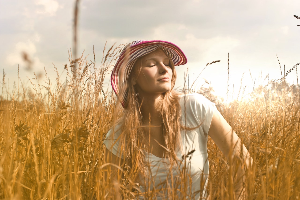 Canva - Woman Wearing White Top and Red and White Sunny Hat